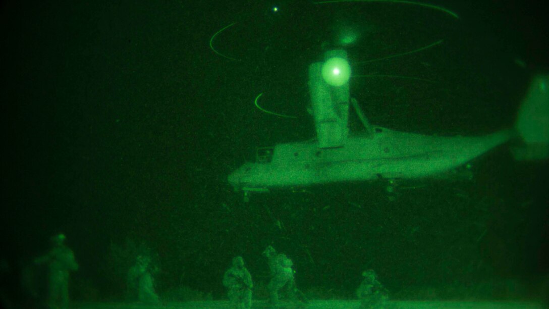 Marines provide security as an MV22B Osprey lands Jan. 10 on Camp Courtney in Okinawa, Japan. The Marines with the 31st Marine Expeditionary Unit’s Maritime Raid Force took part in a night raid as the first of three situational training events that make up the Realistic Urban Training Exercise. The training is designed by Expeditionary Operations Training Group, III Marine Expeditionary Force Headquarters Group, III MEF to test the raid force’s readiness.