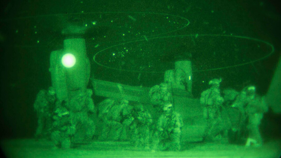 Marines provide security as others board an MV22B Osprey Jan. 10 on Camp Courtney in Okinawa, Japan. The Marines with the 31st Marine Expeditionary Unit’s Maritime Raid Force took part in a night raid as the first of three situational training events that make up the Realistic Urban Training Exercise. Expeditionary Operations Training Group, III Marine Expeditionary Force Headquarters Group, III MEF designed the training to test the MRF’s ability to respond to any contingency or crisis in the United States Pacific Command’s area of responsibility. 