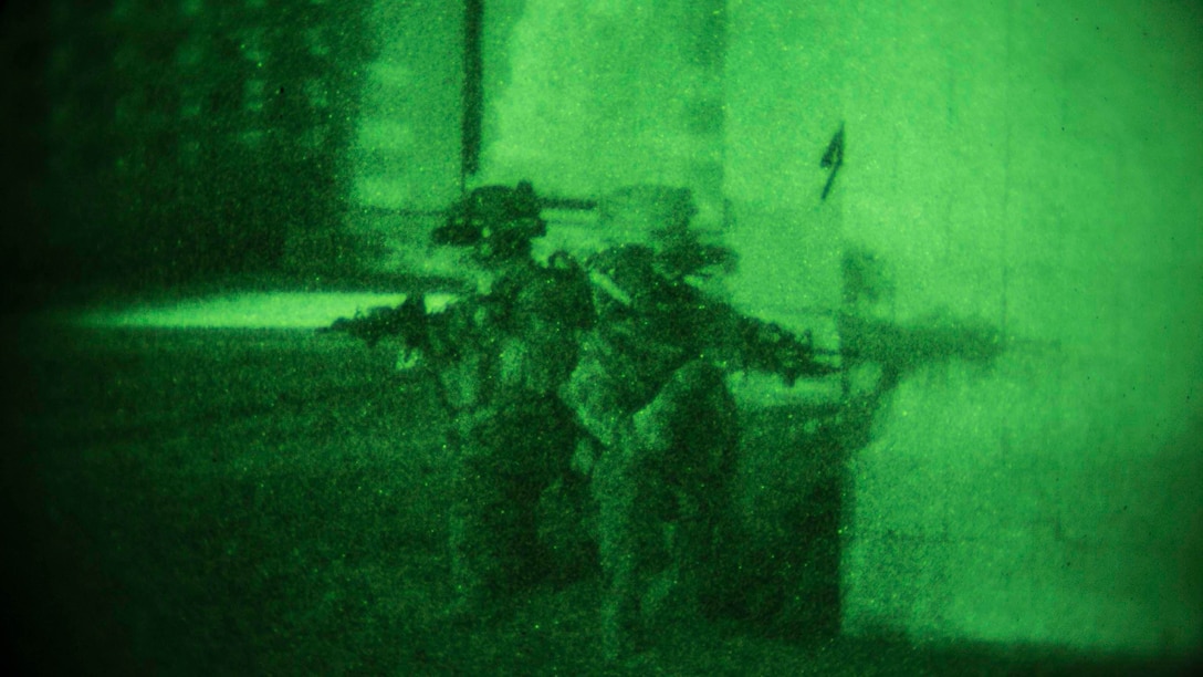 Marines provide security near their objective as their team breaches a doorway Jan. 10 on Camp Courtney in Okinawa, Japan. The Marines with the 31st Marine Expeditionary Unit’s Maritime Raid Force took part in a night raid as the first of three Situational Training Exercises that make up the Realistic Urban Training Exercise. Expeditionary Operations Training Group, III Marine Expeditionary Force Headquarters Group, III MEF designed the training to test the MRF and ensure they are ready to respond to any contingency or crisis in the United States Pacific Command’s area of responsibility. 