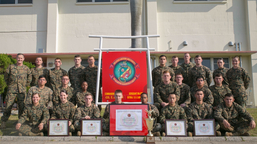 Marines with Headquarters Regiment stand with their maintenance readiness awards from all four quarters and the overall 2014 fiscal year on Camp Kinser, Dec. 31. Headquarters Regiment, 3rd Marine Logistics Group, III Marine Expeditionary Force maintained an overall maintenance readiness of 90% or higher throughout the entire year of 2014. “My success comes from the success of my Marines,” said Col. Edmund J. Bowen, the regiment’s commanding officer, from Staten Island, New York. 