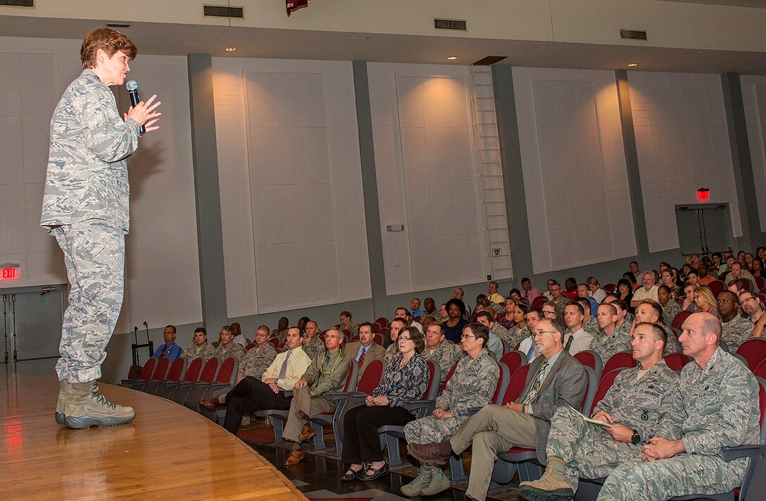 Gen. Janet Wolfenbarger, commander of Air Force Materiel Command, presents information about her command and the new Air Force Installation and Mission Support Center (Provisional) to about 400 members of the Air Force Civil Engineer Center, Air Force Security Forces Center, Air Force Materiel Command Services Directorate and local squadrons assigned to the Air Force Installation Contracting Agency Oct. 9 at a town hall meeting in the Bob Hope Theater at Joint Base San Antonio-Lackland, Texas. (U.S. Air Force photo/Benjamin Faske)