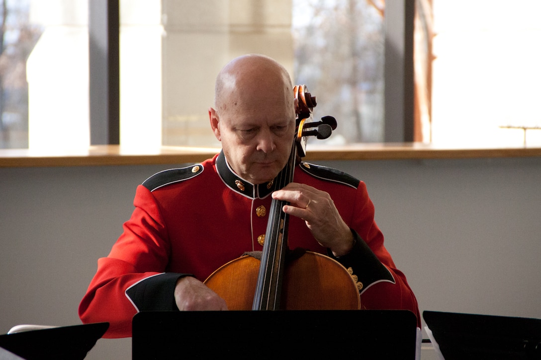On Jan. 11, 2015, the Marine Band performed a concert titled "Sousa Season Opener: By Request" at the George Mason University Center for the Arts. Pictured: Master Gunnery Sgt. Marcio Botelho performs with a string quartet prior to the concert. (U.S. Marine Corps photo by Staff Sgt. Rachel Ghadiali/released)