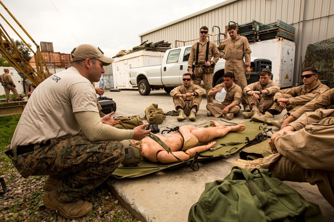 U.S. Marine Gunnery Sgt. Michael Wilkinson teaches Marines with the 15th Marine Expeditionary Unit's Maritime Raid Force how to properly secure injured personnel during maritime interoperability training at Stu Segall production studio, San Diego, Calif., Jan. 9, 2015. Wilkinson is an instructor with Special Training Branch.  MIT prepares the 15th Marine Expeditionary Unit's Maritime Raid Force for their upcoming deployment, enhancing their combat skills by and teaching them techniques for boarding vessels. (U.S. Marine Corps photo by Sgt. Jamean Berry/Released)