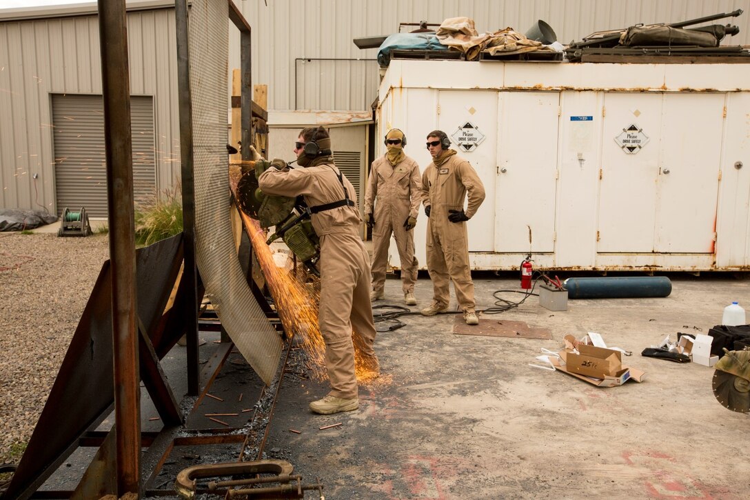 U.S. Marines with the 15th Marine Expeditionary Unit's Maritime Raid Force practice breaching techniques during maritime interoperability training at Stu Segall production studio, San Diego, Calif., Jan. 9, 2015. MIT prepares the 15th MEU's MRF for their upcoming deployment by enhancing their combat skills, and teaching them techniques for boarding vessels. (U.S. Marine Corps photo by Sgt. Jamean Berry/Released)
