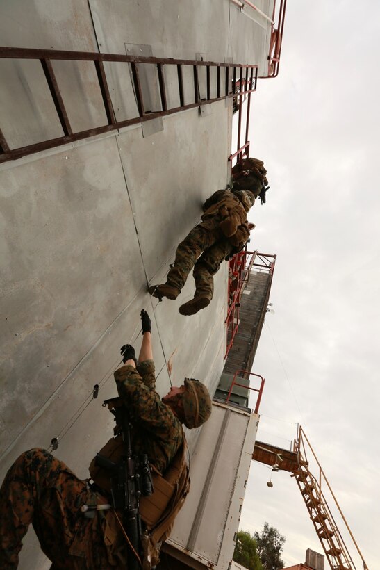 U.S. Marines with the 15th Marine Expeditionary Unit's Maritime Raid Force climb a simulated ship hull during maritime interoperability training at Stu Segall production studio, San Diego, Calif., Jan. 9, 2015. MIT prepares the 15th MEU's MRF for their upcoming deployment by enhancing their combat skills, and teaching them techniques for boarding vessels. (U.S. Marine Corps photo by Sgt. Jamean Berry/Released)