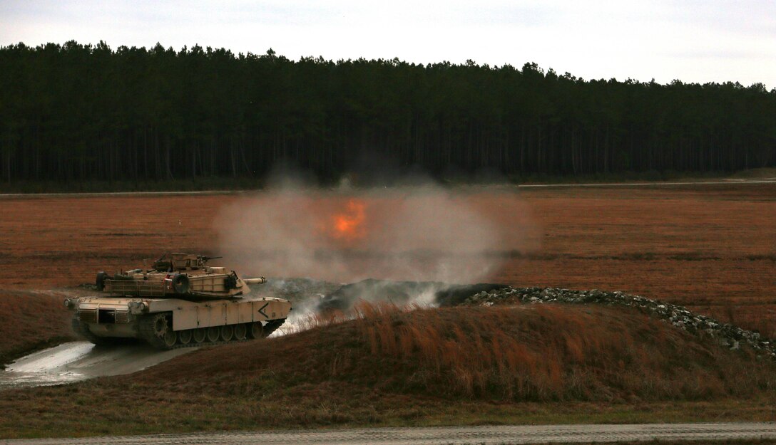 Marines with Tank Platoon, Company B, Ground Combat Element Integrated Task Force, fire the 120mm main gun of the M1A1 Abrams tank during a live-fire training exercise at Range SR-10, Marine Corps Base Camp Lejeune, North Carolina, Jan. 13, 2015. Marines with Tank Platoon conducted offensive and defensive engagements to prepare for an upcoming assessment at Marine Corps Air Ground Combat Center Twentynine Palms, California. From October 2014 to July 2015, the GCEITF will conduct individual and collective level skills training in designated ground combat arms occupational specialties in order to facilitate the standards based assessment of the physical performance of Marines in a simulated operating environment performing specific ground combat arms tasks.
