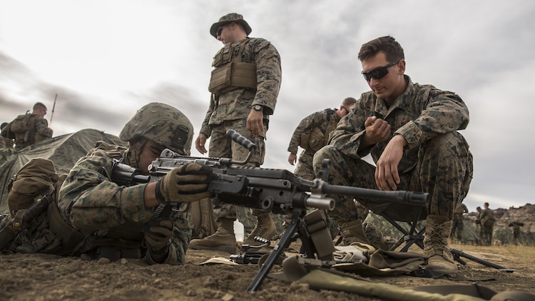 U.S. Marine Lance Cpl. Joseph Burk trains his Marines on weapons handling during a combined arms exercise aboard Marine Corps Air Ground Combat Center, Twentynine Palms, Calif., Dec. 10, 2014. Burk is a team leader with Battalion Landing Team 3rd Battalion, 1st Marine Regiment, 15th Marine Expeditionary Unit. (U.S. Marine Corps Photo by Sgt. Emmanuel Ramos/Released)