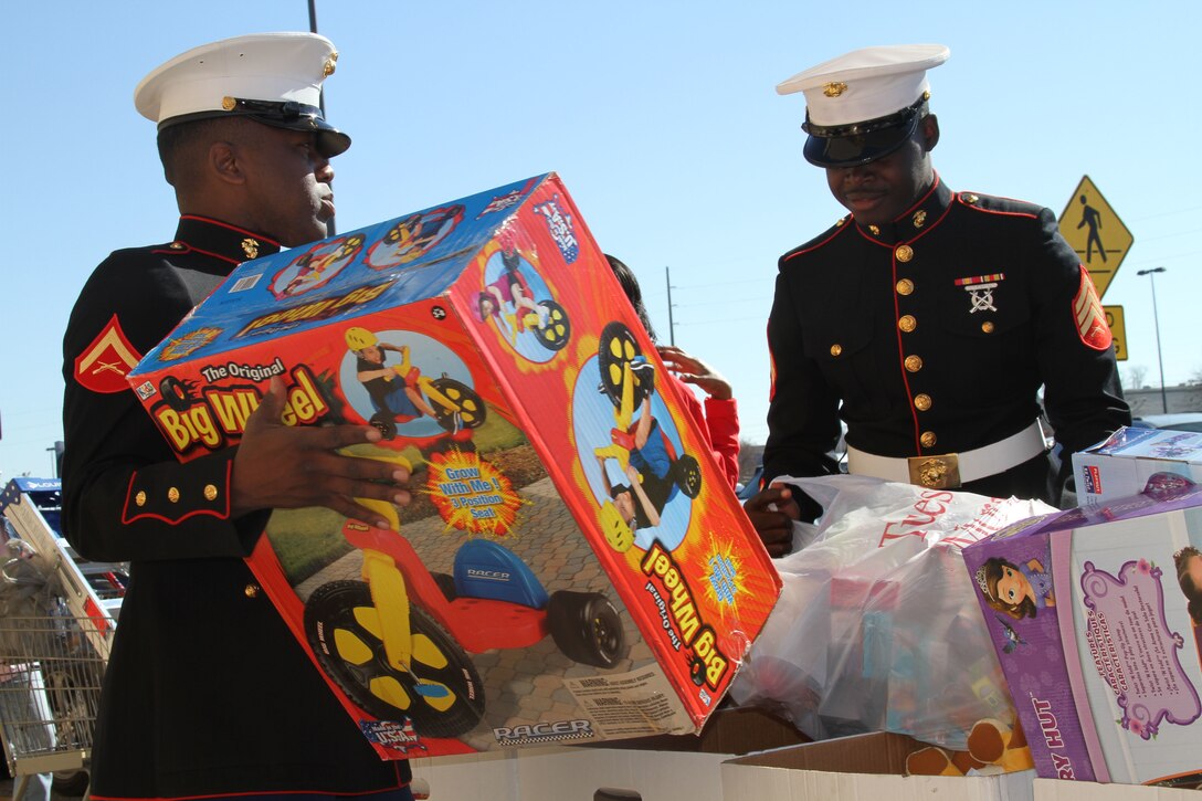 Lance Cpl. Gentres Anderson, from Pensacola, Florida, and Sgt. Sheldon Curry, from Montgomery, Alabama, help bring toys to the donation bins for the Marines' Toys for Tots Program in Montgomery, Alabama, Dec. 13, 2014. The program found its roots in 1947 Los Angeles when Marine Maj. Bill Hendricks, a reservist, collected more than 5,000 toys to help his community. The Marine Corps formally adopted the program the very next year, and it has continued to this day. “This is a great chance for us to give back to the community and help those families in need,” said Curry, who has lived his whole life in Montgomery. “I come from a family that didn’t have anything. We got fruit – apples, oranges – for Christmas. This makes a difference.” “Those kids that don’t have anything,” Curry added. “They really appreciate just having a gift.”