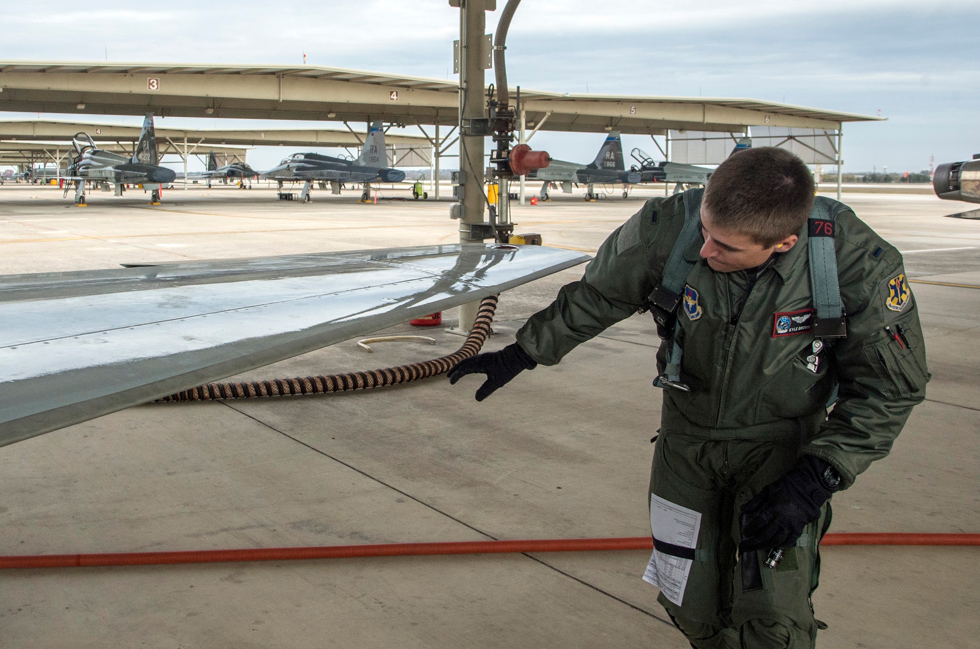 First Lt. Kyle Brown, 435th Fighter Training Squadron, inspects a T-38 during a pre-flight inspection prior to a morning training flight Jan. 8, 2015, at Joint Base San Antonio-Randolph. During preflight inspections, aircrew members examine the exterior and interior of aircraft, checking for discrepancies and ensuring serviceability. (U.S. Air Force photo by Johnny Saldivar)