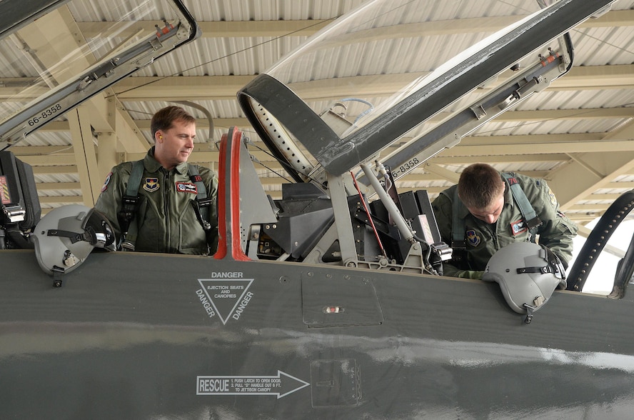 First Lt. Kyle Brown and Lt. Col. Michael Whyte, 435th Fighter Training Squadron, inspect cockpit instruments during a pre-flight inspection prior to a morning training flight Jan. 8, 2015, at Joint Base San Antonio-Randolph. During preflight inspections, aircrew members check the exterior and interior of aircraft, checking for discrepancies and ensuring serviceability. (U.S. Air Force photo by Johnny Saldivar)