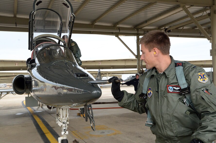 First Lt. Kyle Brown, 435th Fighter Training Squadron, inspects a T-38 during a pre-flight inspection prior to a morning training flight Jan. 8, 2015, at Joint Base San Antonio-Randolph. During preflight inspections, aircrew members examine the exterior and interior of aircraft, checking for discrepancies and ensuring serviceability. (U.S. Air Force photo by Johnny Saldivar)