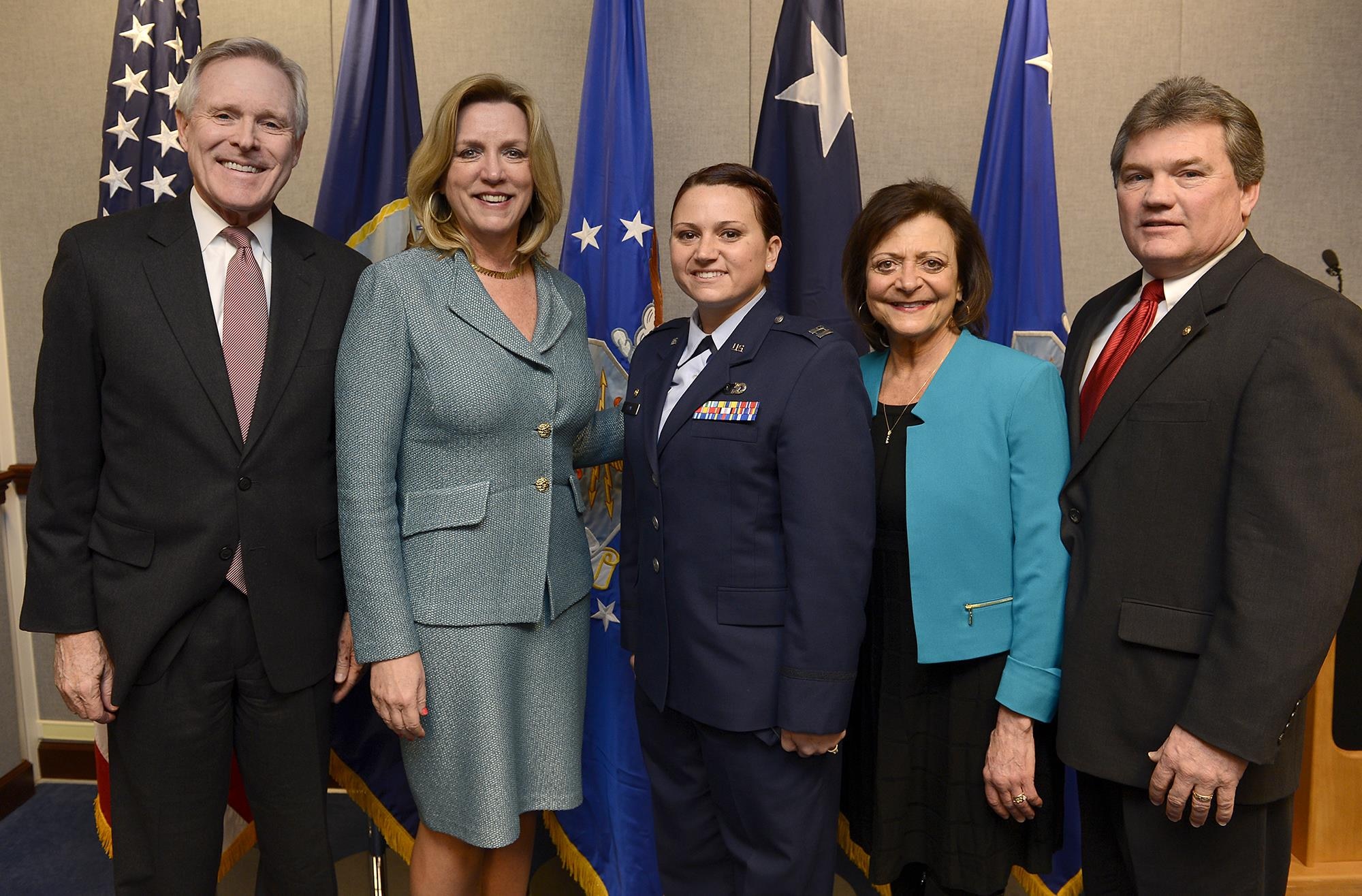 Secretary of the Navy Ray Mabus and Secretary of the Air Force Deborah Lee James congratulate Capt. Dana Lyon and her parents, Rick and Nancy Pounds, during a naming ceremony, of the Motor Vessel Capt. David I. Lyon, Jan. 14, 2015, in the Pentagon.  The vessel was named in honor of Capt. David Lyon, who was killed in action Dec. 27, 2013, while serving in support of Operation Enduring Freedom.  (U.S. Air Force photo/Scott M. Ash)