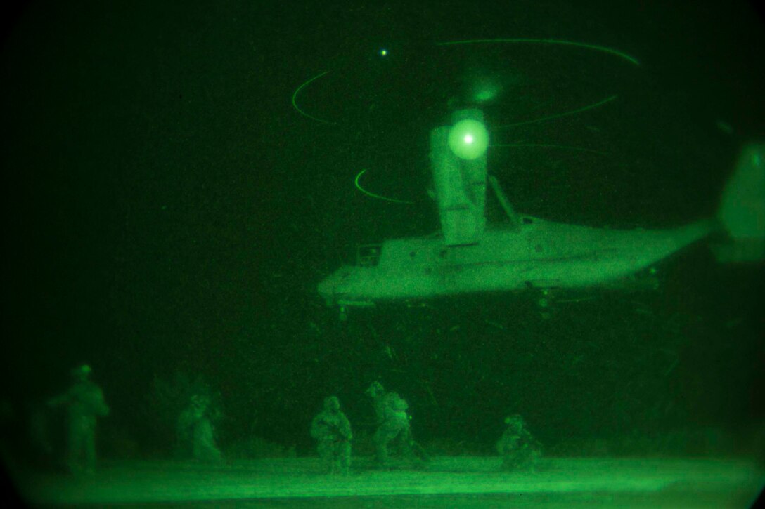 Marines provide security as an MV22B Osprey lands Jan. 10 on Camp Courtney in Okinawa, Japan. The Marines with the 31st Marine Expeditionary Unit’s Maritime Raid Force took part in a night raid as the first of three situational training events that make up the Realistic Urban Training Exercise. The training is designed by Expeditionary Operations Training Group, III Marine Expeditionary Force Headquarters Group, III MEF to test the raid force’s readiness.