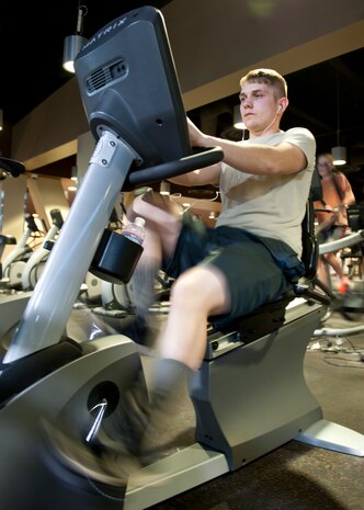 Ryan Wertz, a line delivery technician assigned to the 1st Maintenance Squadron, Joint Base Langley-Eustis, Va., works out on an exercise bike at  the Warrior Fitness Center on Nellis Air Force Base, Nev., Jan. 14, 2015. Airmen can take advantage of many programs offered at the fitness center such as Bujutsu and Zumba classes, as well as the Health and Wellness Center's six-week running clinic. Contact the fitness center at 702-652-4891 or the HAWC at 702-652-4891 for more information on these and other programs. (U.S. Air Force photo by Senior Airman Thomas Spangler)