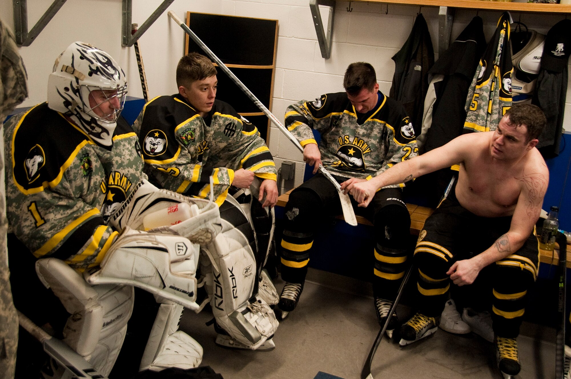 Members of the Army Hockey Team from Joint Base Elmendorf-Richardson rest before the start the second period during the second annual Army vs Air Force Hockey Game at the Sullivan Arena, January 9, 2015. The JBER Army vs Air Force Hockey Game is an opportunity for friendly athletic competition, a way to foster esprit de corps between JBER military branches and to reach the local community. The Air Force defeated Army this year 7 to 5. (Air Force photo by SSgt. William Banton/Released)
 

 
