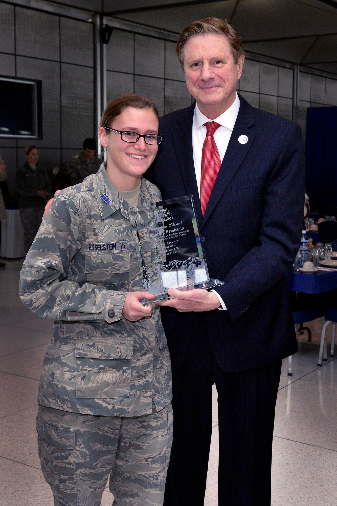 Colorado Springs mayor Steve Bach presents Cadet 1st Class Rebecca Esselstein with the Spirit of the Springs Award at the Staff Tower here Jan. 14, 2014. The award recognizes her selection as a Rhodes scholar and her military, academic and athletic achievements at the Academy. Esselstein was recently selected for a Rhodes scholarship and is one of 38 Academy cadets to receive the Spirit of the Springs Award. (U.S. Air Force photo/Jason Gutierrez)