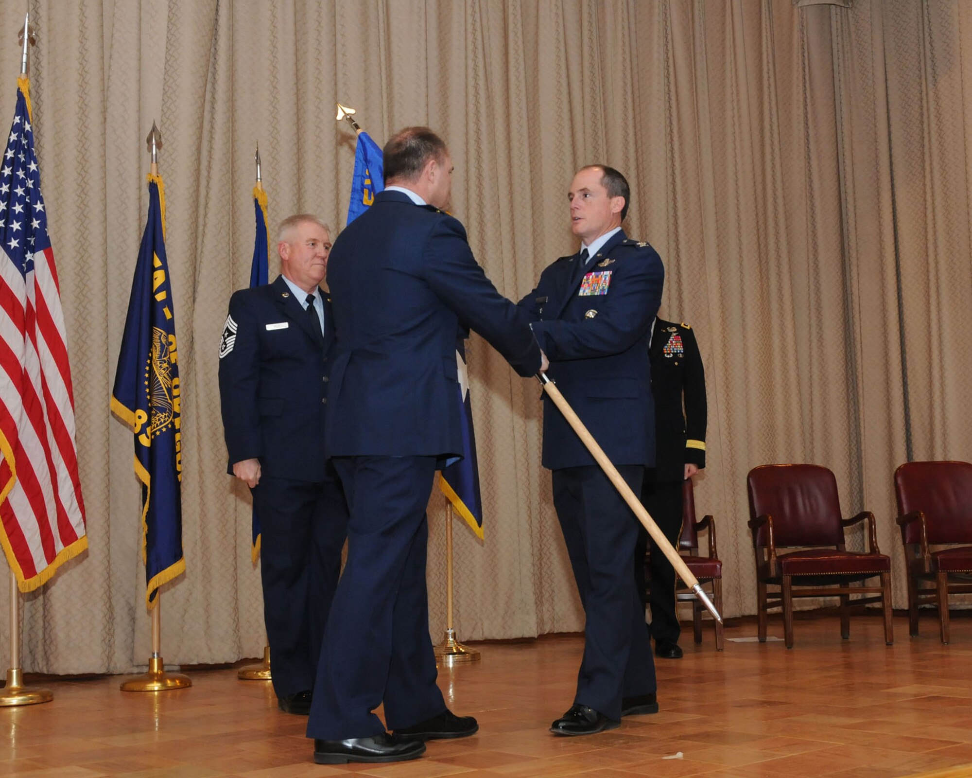 U.S. Air Force Brigadier General Michael Stencel, Oregon Air National Guard Commander, presents the 173rd Fighter Wing guidon to Colonel Kirk Pierce, the incoming 173rd FW Commander, during an Assumption of Command ceremony at Kingsley Field, Klamath Falls, Ore. Jan. 10, 2015.  Pierce has 26 years of military service and was previously assigned as the Director of Plans and Programs for the National Guard Bureau. (U.S. Air National Guard photo by Senior Airman Penny Snoozy/Released)