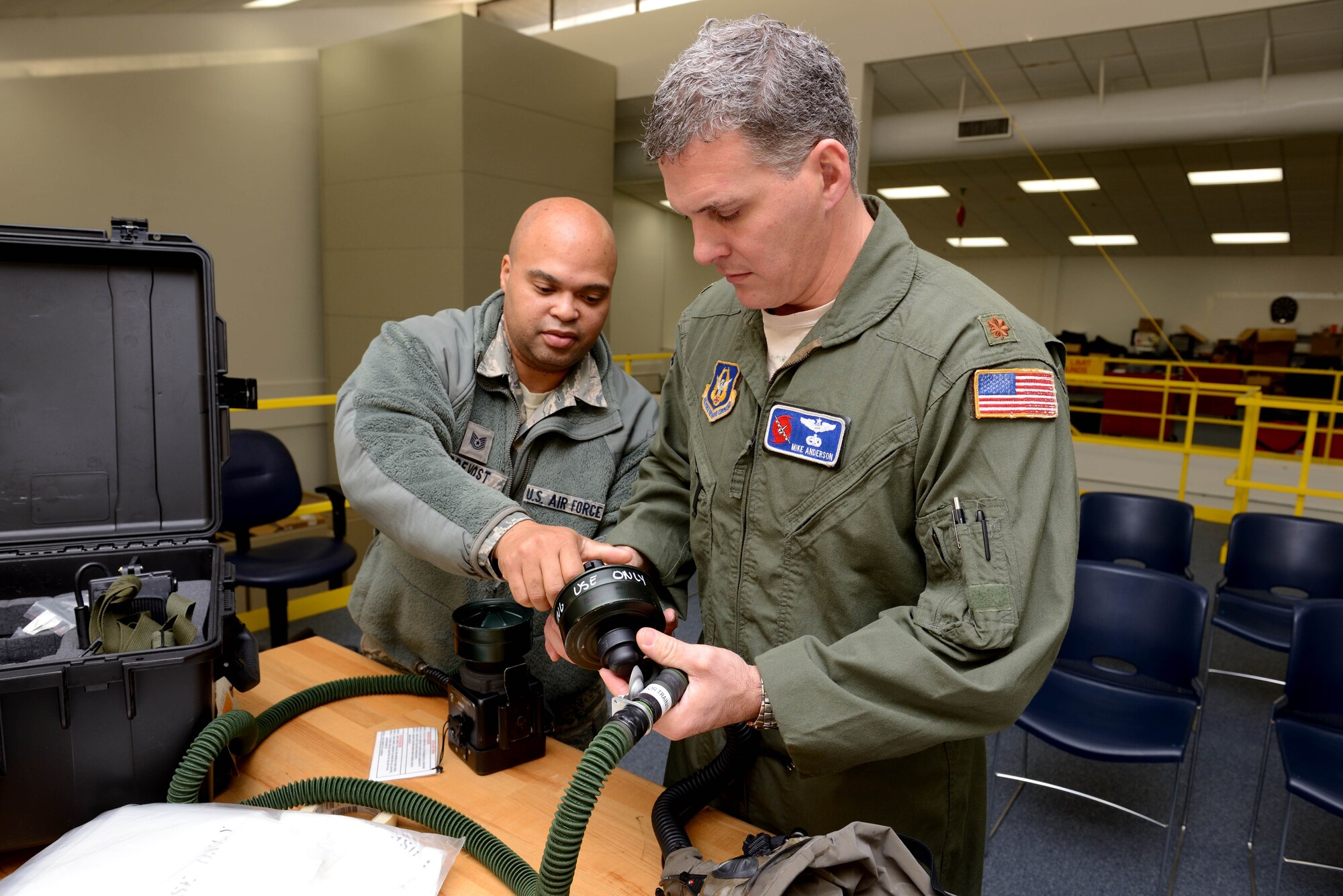 Tech. Sgt. Marlon Prevost, 403rd Operations Support Squadron aircrew flight equipment technician, provides refresher training on assembling aircrew chemical warfare equipment to Maj. Mike Anderson, 53rd Weather Reconnaissance Squadron navigator January 10, 2015. The 403rd OSS provides training, information and equipment support for aircrew members of the 53rd Weather Reconnaissance Squadron, and 815th and 345th Airlift Squadrons, all of which are assigned to the 403rd Wing at Keesler Air Force Base, Mississippi. (U.S. Air Force photo/Tech. Sgt. Ryan Labadens)