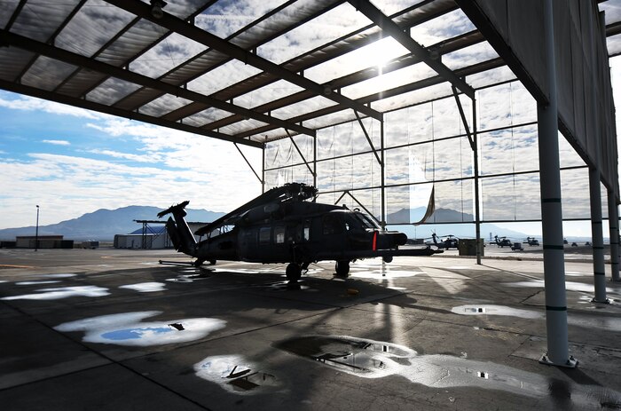 An HH-60G Pave Hawk assigned to the 66th Rescue Squadron sits under a canopy at Nellis Air Force Base, Nev., Jan. 12, 2015. This HH-60 is awaiting an upcoming deployment to southwest Asia. Airmen assigned to the 823rd Maintenance Squadron will accompany the helicopter to ensure the aircraft is mission ready to conduct personnel recovery missions. (U.S. Air Force photo by Airman 1st Class Rachel Loftis)