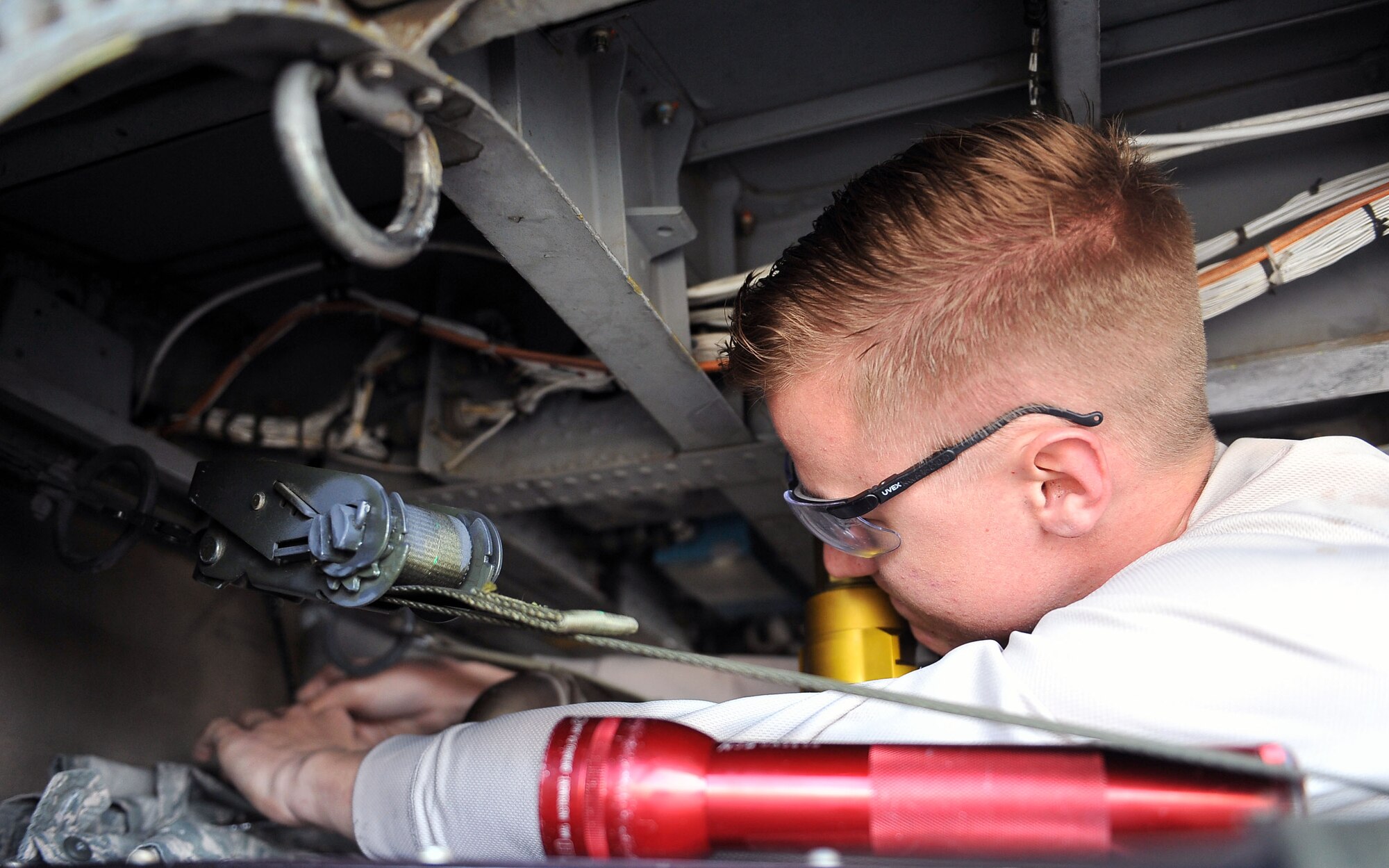 Airman 1st Class Austin Williams, 823rd Maintenance Squadron guidance and control avionics maintainer, performs maintenance on an HH-60G Pave Hawk at Nellis Air Force Base, Nev. Jan. 12, 2015. Airmen at the 823rd MXS are capable of performing intermediate, organizational and depot level maintenance on HH-60s. (U.S. Air Force photo by Airman 1st Class Rachel Loftis)