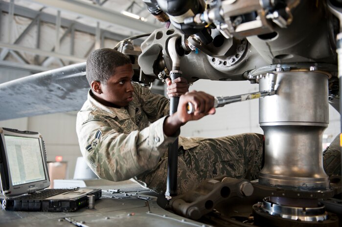 Airman 1st Class Carlos Thompson, 823rd Maintenance Squadron HH-60G Pave Hawk crew chief, performs maintenance on an HH-60 at the 823rd MXS hangar at Nellis Air Force Base, Nev., Jan. 12, 2015. The 823rd MXS is responsible for the maintenance and upkeep of 18 HH-60 s. (U.S. Air Force photo by Senior Airman Thomas Spangler)