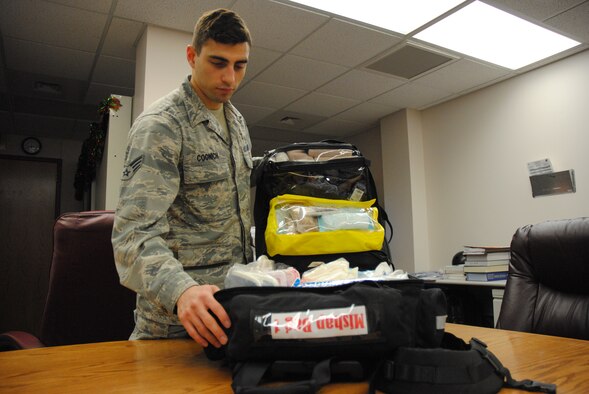 Senior Airman Joshua Coonich, 348th Reconnaissance Squadron aerospace medical technician, opens his mishap bag Dec. 24, 2014, at medical treatment facility on Grand Forks Air Force Base, N.D. The mishap bag serves as a medical kit, and is used to treat people who may have been injured in incidents such a plane crash. (U.S. Air Force photo/Staff Sgt. Luis Loza Gutierrez) 