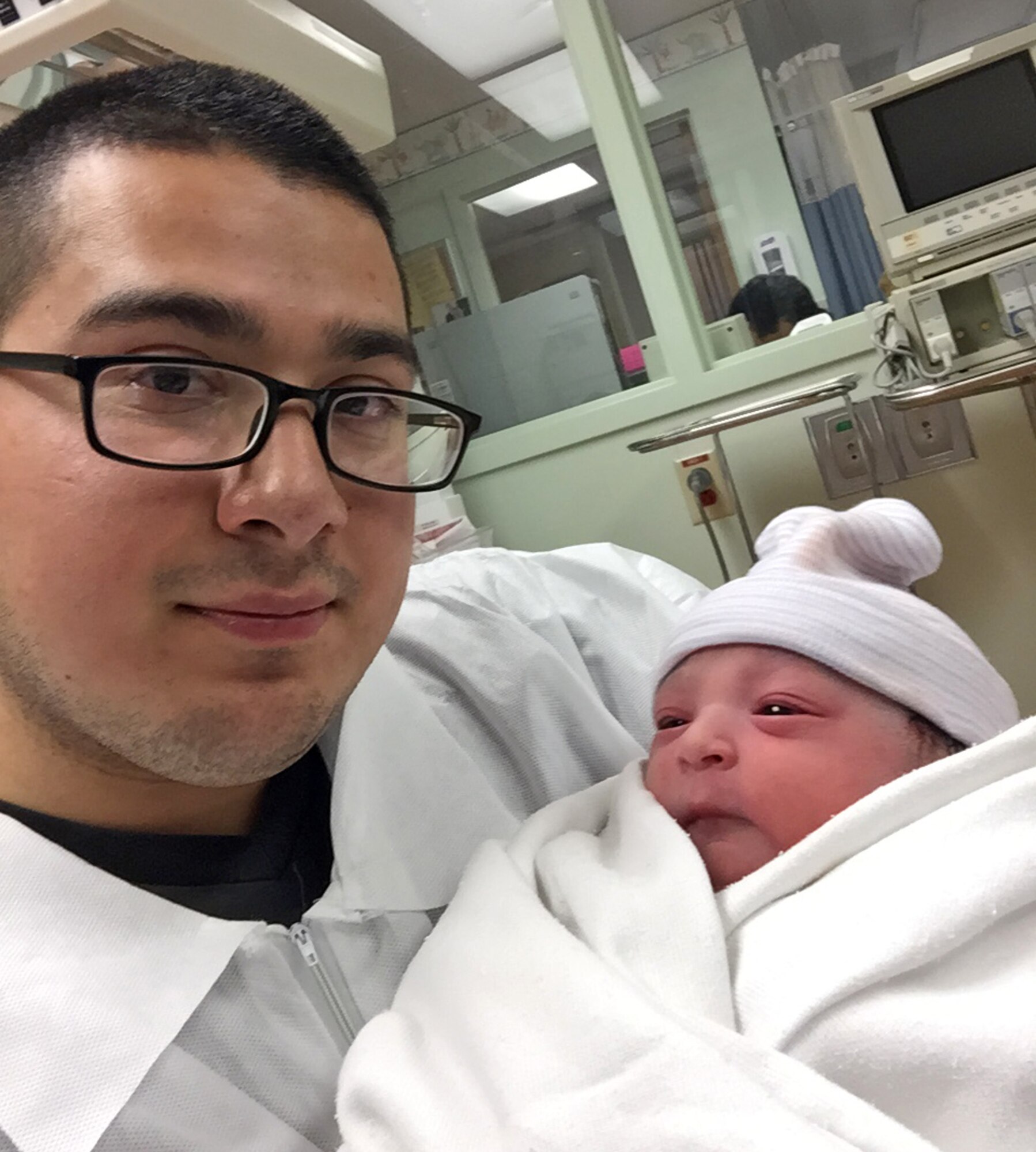 Senior Airman Rolando Alvarado, 9th Force Support Squadron force management technician, hold his newborn child. (Courtesy photo)