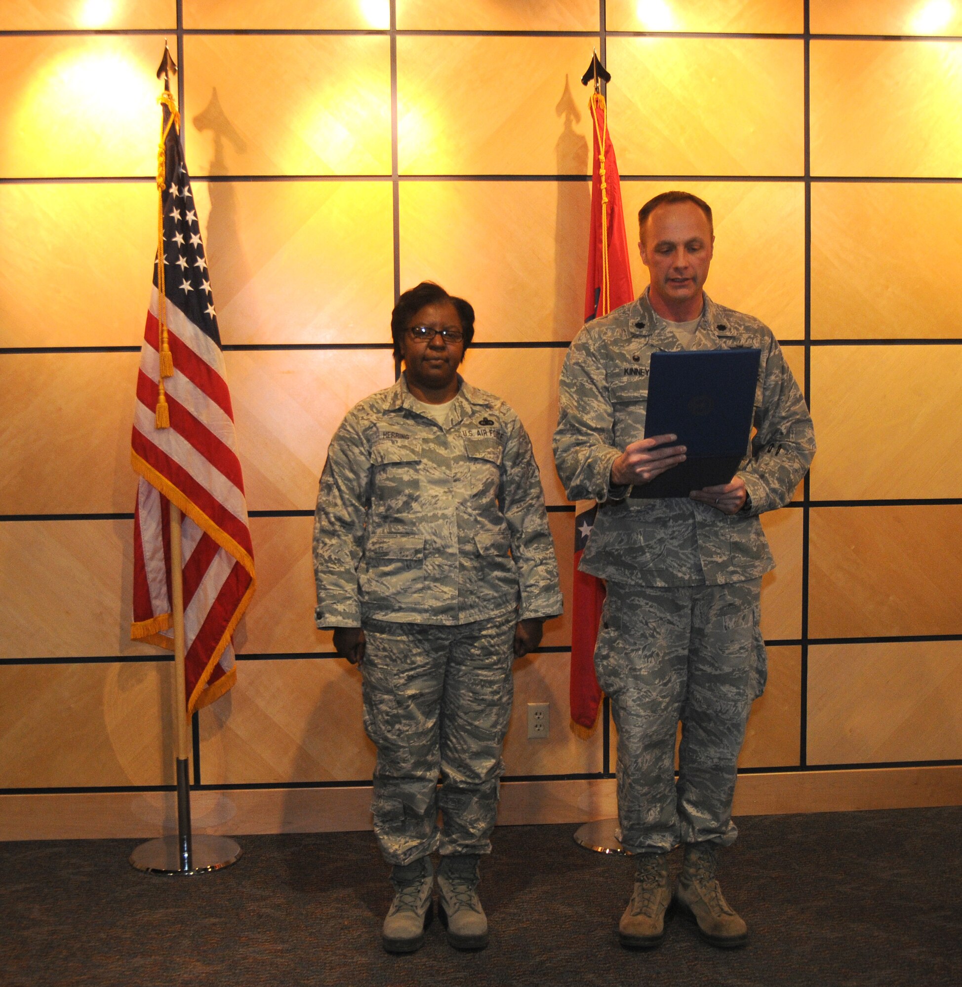 Lt. Col. Robert Kinney, 188th Intelligence, Surveillance and Reconnaissance Group commander, reads the order during a promotion ceremony for Chief Master Sgt. Brenda Herring of the 123rd Intelligence Squadron at the headquarters auditorium at Ebbing Air National Guard Base, Fort Smith, Ark., Jan. 11, 2015. Herring has served 23 years in the Air National Guard and has been with the 123rd for almost nine years. (U.S. Air National Guard photo by Airman 1st Class Cody Martin/released)