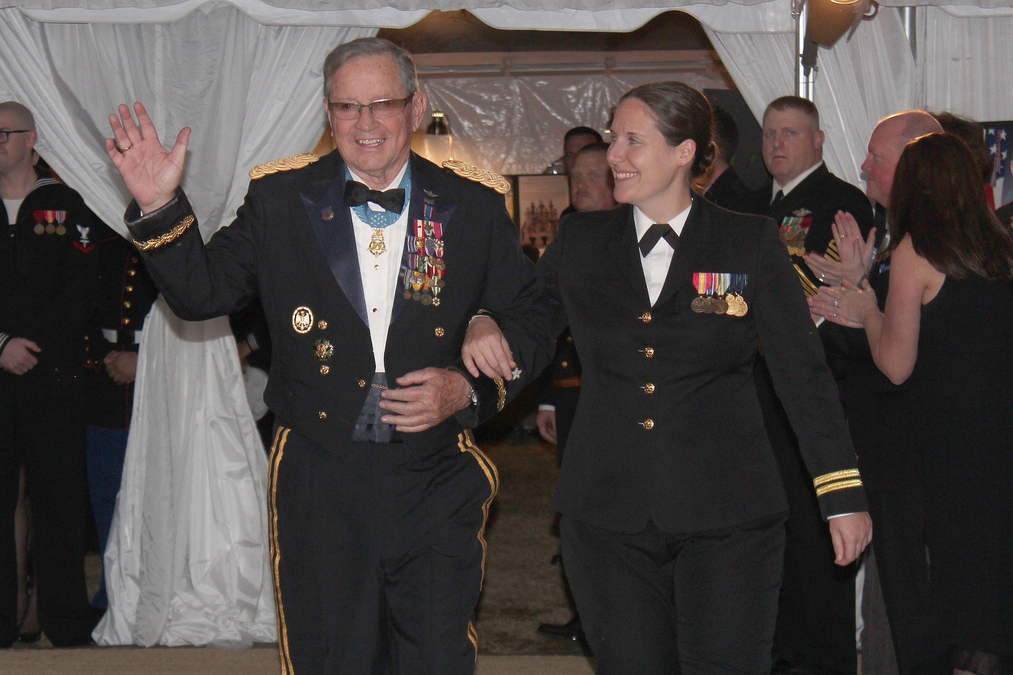 Medal of Honor recipient, Army Maj. Gen. (ret) Patrick Brady is escorted by Navy Lt. Angela Mound into the True Blue Gala, Jan. 9, 2014 at Patriots Point, Mount Pleasant, S.C. The True Blue Gala honored some of our nation's greatest military heroes and was one of many events throughout the week benefitting the National Medal of Honor Museum Foundation. Mound is assigned to the Naval Nuclear Power Training Command at Joint Base Charleston - Weapons Station. (Courtesy Photo)