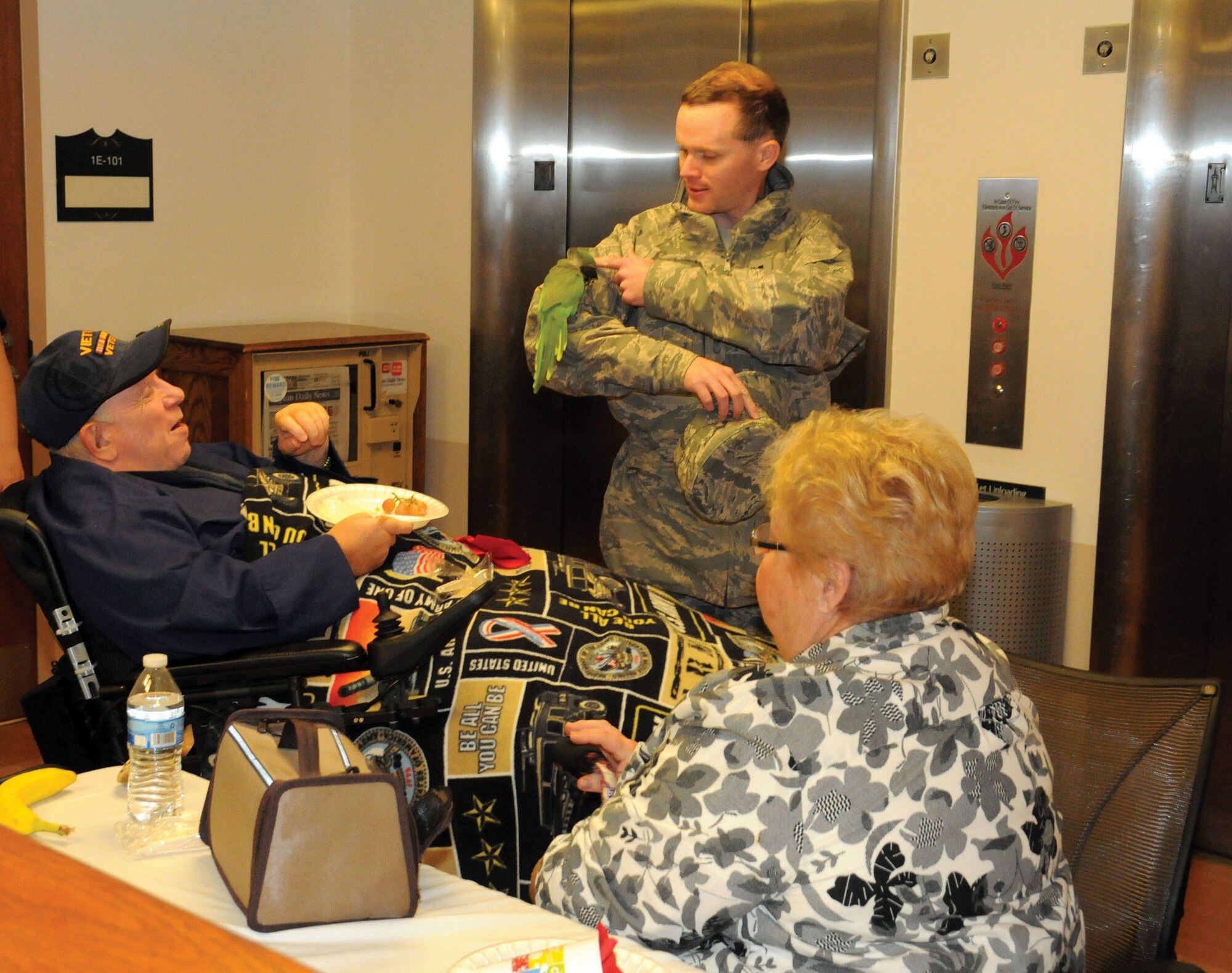 DAYTON, Ohio - Chaplain (Capt.) Luke McKeeth, 445th Airlift Wing Chaplain Corps, pets an exotic bird used for therapy during the wing's visit to the Dayton Veterans Affairs Medical Center Community Living Center December 6, 2014. More than 250 volunteers, military and family enjoyed a holiday party featuring a flag raising ceremony and lunch. (U.S. Air Force photo/Tech. Sgt. Anthony Springer)