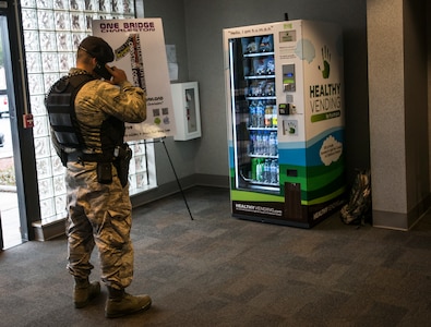 Senior Airman Tony Roybal, 628th Security Forces Squadron patrolman, notifies the 628th Civil Engineering Squadron’s Explosive Ordinance Disposal team of a suspicious package at the Air Base fitness center during an exercise Jan. 14, 2015, at Joint Base Charleston, S.C. JB Charleston held an exercise Jan. 14 through 15 to test the implementation of Force Protection levels in the event of an on base disturbance. (U.S. Air Force photo/ Senior Airman Dennis Sloan)