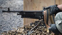 An Airman assigned to the 919th Special Operations Security Forces Squadron feeds the M240-B for his partner to complete heavy weapons qualification firing Jan 10, 2015 at Duke Field, Fla.  (U.S. Air Force photo/ Tech. Sgt. Jasmin Taylor)