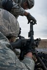 Senior Airman Kendrick Woodson, 919th Special Operations Security Forces Squadron, reloads the M240-B during the heavy weapons qualification firing Jan 10, 2015 at Duke Field, Fla.  (U.S. Air Force photo/ Tech. Sgt. Jasmin Taylor)