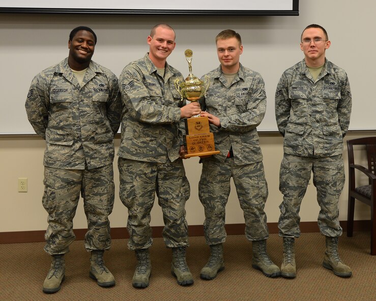 From left, Staff Sgt. Raymond Edgerson Jr., Senior Airman Tyler Branch, Airmen 1st Class Kevin Gantt and Jaeden Sarvello, 96th Aircraft Maintenance Unit Cobra 6 team members, pose for a photo on Barksdale Air Force Base, La., Jan. 9, 2015 . Cobra 6 won the quarterly weapons load competition, beating the 20th AMU and holding the trophy until the next competition. (U.S. Air Force photo/Senior Airman Joseph A. Pagán Jr.)