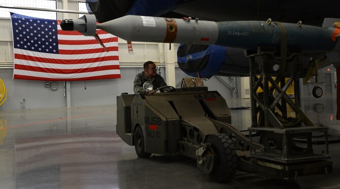 Airman 1st Class Jaeden Sarvello, 96th Aircraft Maintenance Unit Cobra 6 team member, waits to load a Guided Bomb Unit-12 onto a B-52H Stratofortess during the quarterly weapons load competition inside the Weapons Load Training hanger on Barksdale Air Force Base, La., Jan. 9, 2015. Two teams competed to see which unit could inspect, prepare and load weapons onto a B-52H Stratofortress with the least amount of discrepancies. (U.S. Air Force photo/Senior Airman Joseph A. Pagán Jr.)