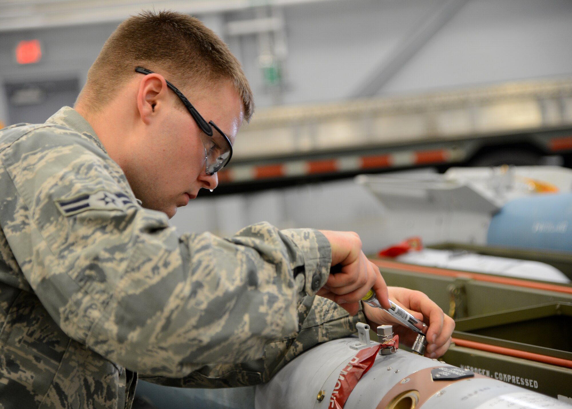 Airman 1st Class Kevin Gantt, 96th Aircraft Maintenance Unit Cobra 6 team member, tightens a bolt on a Guided Bomb Unit-12 during the quarterly weapons load competition inside the Weapons Load Training hanger on Barksdale Air Force Base, La., Jan. 9, 2015. Gantt was in charge of making sure all bombs were prepared and ready to load onto a B-52H Stratofortress. (U.S. Air Force photo/Senior Airman Joseph A. Pagán Jr.)