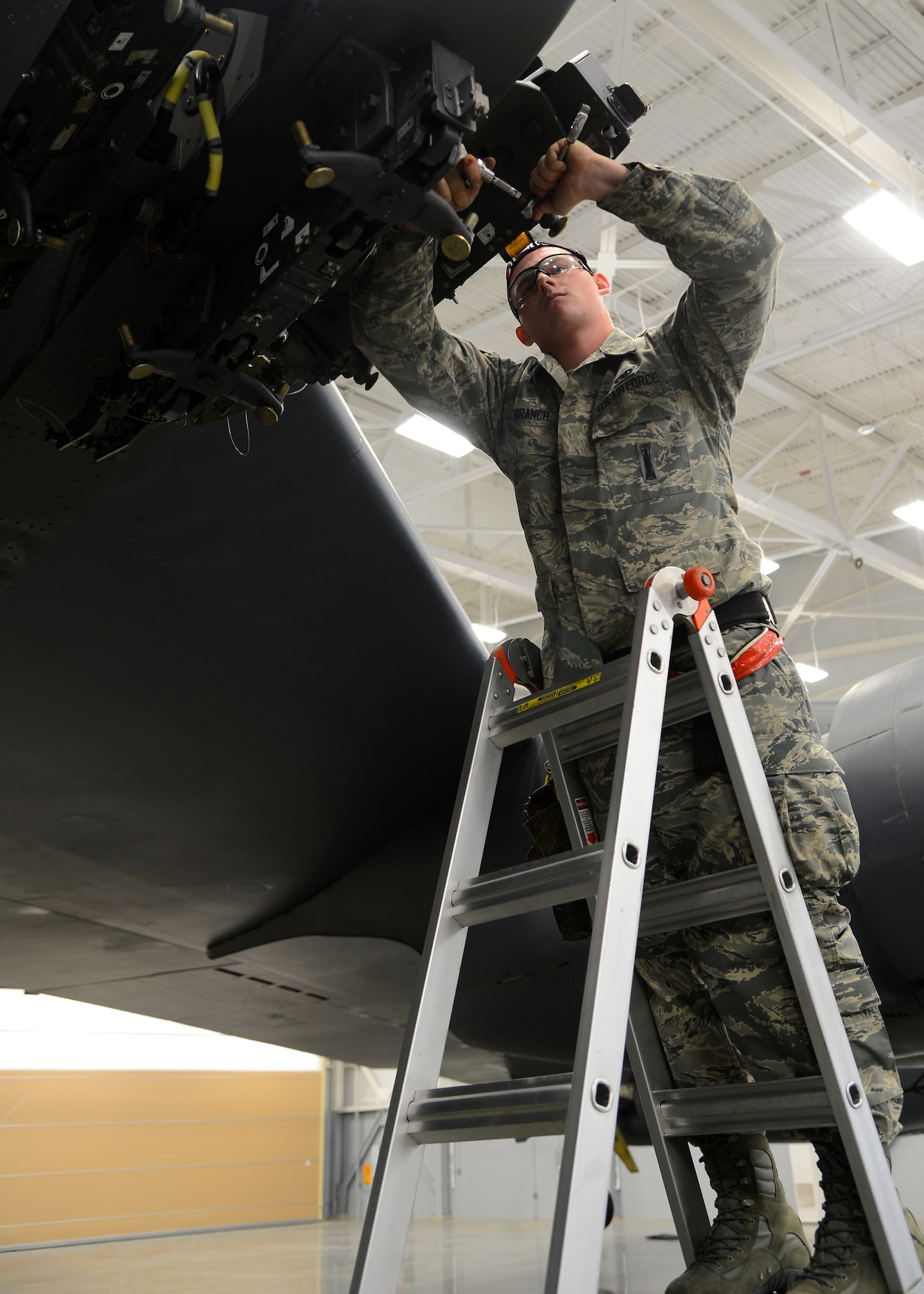 Senior Airman Tyler Branch, 96th Aircraft Maintenance Unit Cobra 6 team member, prepares a MAU-12 for a weapon load inside the Weapons Load Training hanger on Barksdale Air Force Base, La., Jan. 9, 2015. The MAU-12 ejector rack attaches to a pylon on the wing of a B-52H Stratofortress and can hold up to nine MAU-12s and their connecting bombs. (U.S. Air Force photo/Senior Airman Joseph A. Pagán Jr.)