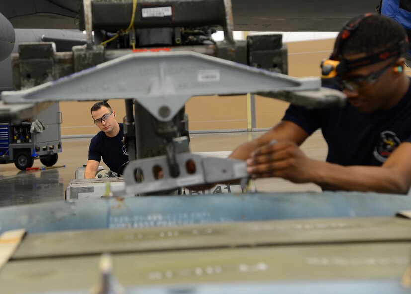 Airman 1st Class Jebediah Ramsey, left, and Senior Airman Benl Williams, 20th Aircraft Maintenance Unit Viper 6 team members, work together to load a Guided Bomb Unit-12 onto a MHU-83 lift during the quarterly weapons load competition inside the Weapons Load Training hanger on Barksdale Air Force Base, La., Jan. 9, 2015. The competition involved inspecting, preparing and loading three M117 general purpose bombs and two Guided Bomb Units onto a B-52H Stratofortress. (U.S. Air Force photo/Senior Airman Joseph A. Pagán Jr.)