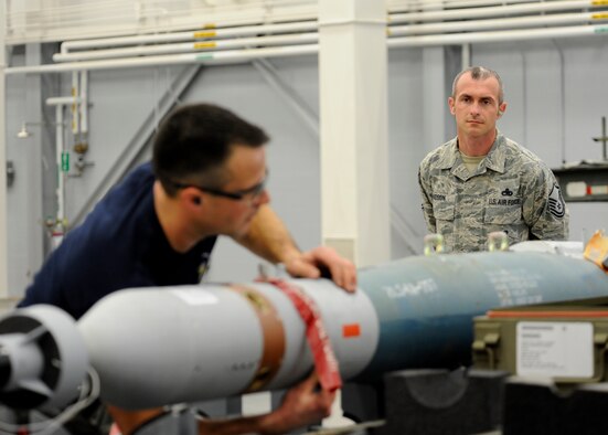 Master Sgt. Michael Lyle, 2nd Maintenance Group loading standardization crew member, inspects Airman 1st Class Jebediah Ramsey, 20th Aircraft Maintenance Unit Viper 6 team member, while he prepares a Guided Bomb Unit-12 during the quarterly weapons load competition inside the Weapons Load Training hanger on Barksdale Air Force Base, La., Jan. 9, 2015. Lyle was one of four inspectors observing the 20th and 96th AMU during the competition to see which unit could inspect, prepare and load weapons onto a B-52H Stratofortress with the least amount of discrepancies. (U.S. Air Force photo/Senior Airman Joseph A. Pagán Jr.)