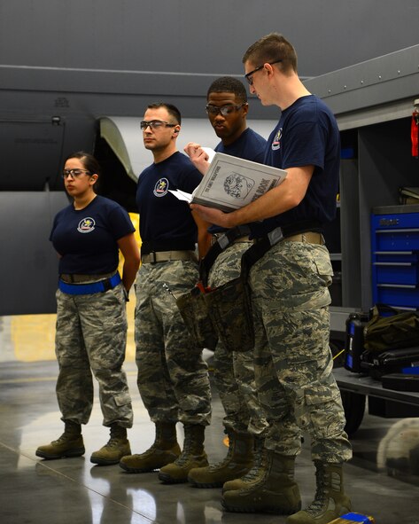 Airmen from the 20th Aircraft Maintenance Unit wait to begin the quarterly weapons load competition inside the Weapons Load Training hanger on Barksdale Air Force Base, La., Jan. 9, 2015. Two four-man teams from the 20th and the 96th AMU competed to see which team could inspect, prepare and load weapons onto a B-52H Stratofortress with the least amount of discrepancies. (U.S. Air Force photo/Senior Airman Joseph A. Pagán Jr.)