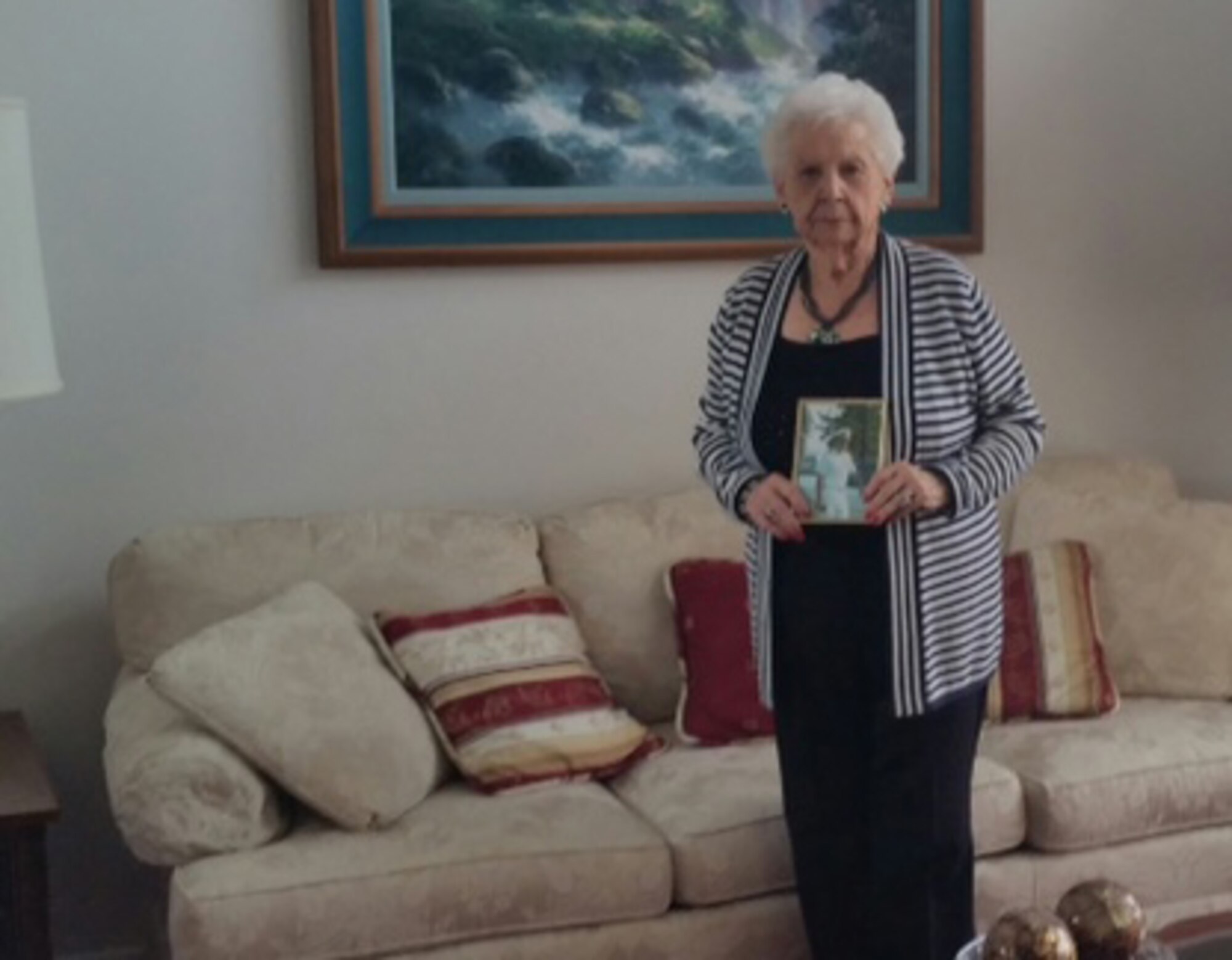 Patrick Air Force Base, Florida, resident Therese Sisson holds a photo of her late husband, retired U.S. Navy Commander Donald Sisson. Because of her late husband’s service, Sisson has lived in a Hunt Companies home on the base since 2010. As a widow of a retired veteran, Sisson is at the top of the tiered list of civilian tenants eligible to live on base when active-duty occupancy rates drop below 95 percent. (Photo courtesy of Hunt Companies)