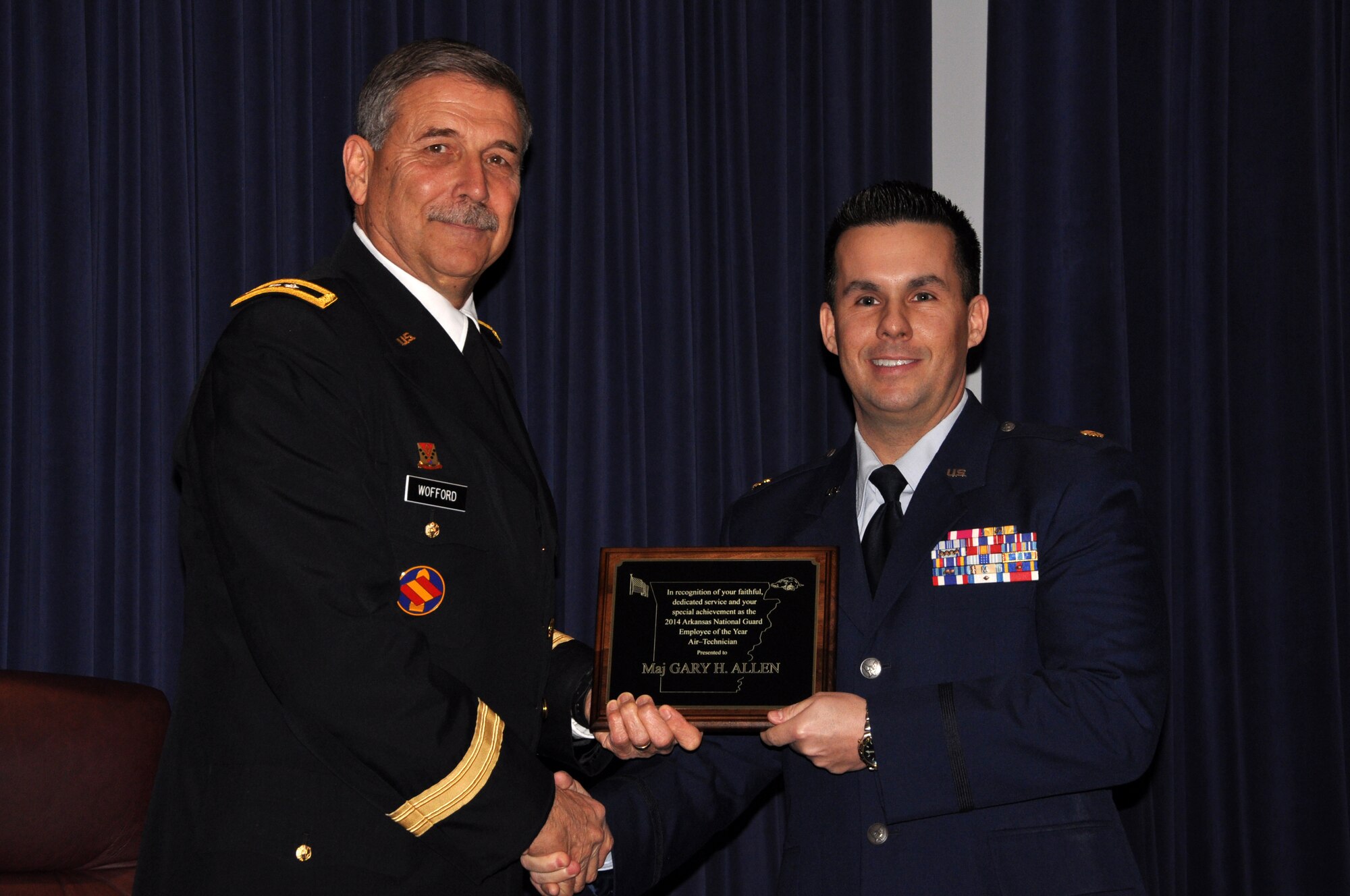 Maj. Gen. William Wofford, then-Arkansas National Guard adjutant general, left, presents Maj. Heath Allen of the 188th Wing the award as the Outstanding Air National Guard Federal Military Technician of the Year for 2014 during the annual Employee of the Year Awards ceremony held Jan. 6, 2015, at Camp Joseph T. Robinson, Ark. (U.S. Air National Guard photo by Lt. Col. Keith Moore/released)
