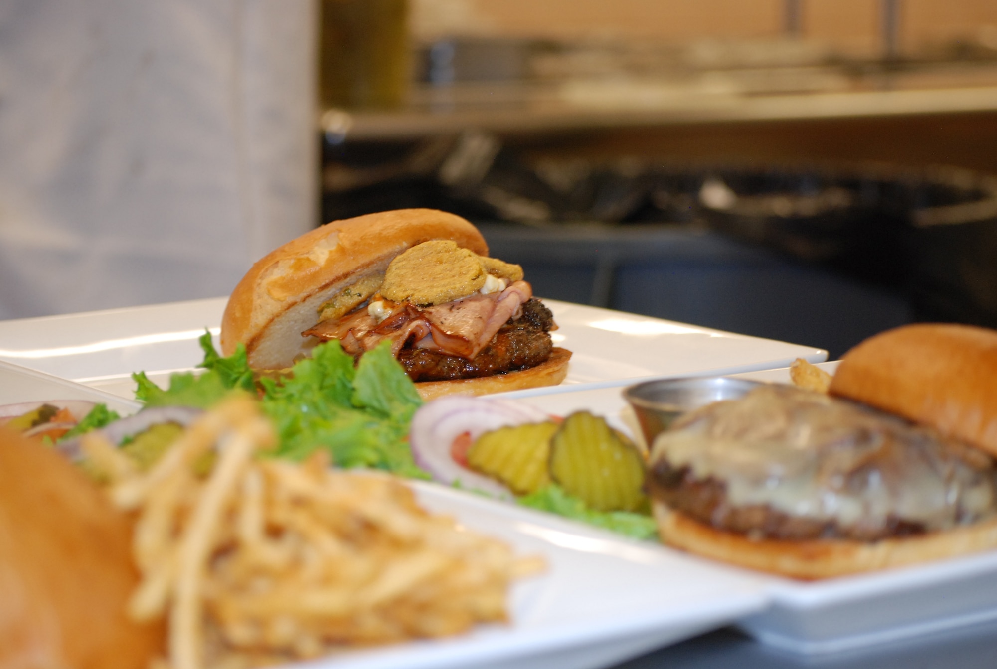 PETERSON AIR FORCE BASE, Colo. -- The Club Big Boy, topped with buffalo sauce, bleu cheese, grilled ham and fried pickles is just one of six new gourmet burgers offered at the Club. The burger lineup is one of several changes that have taken place at the facility, with more expected to come in 2015. (U.S. Air Force photo by Dave Smith)