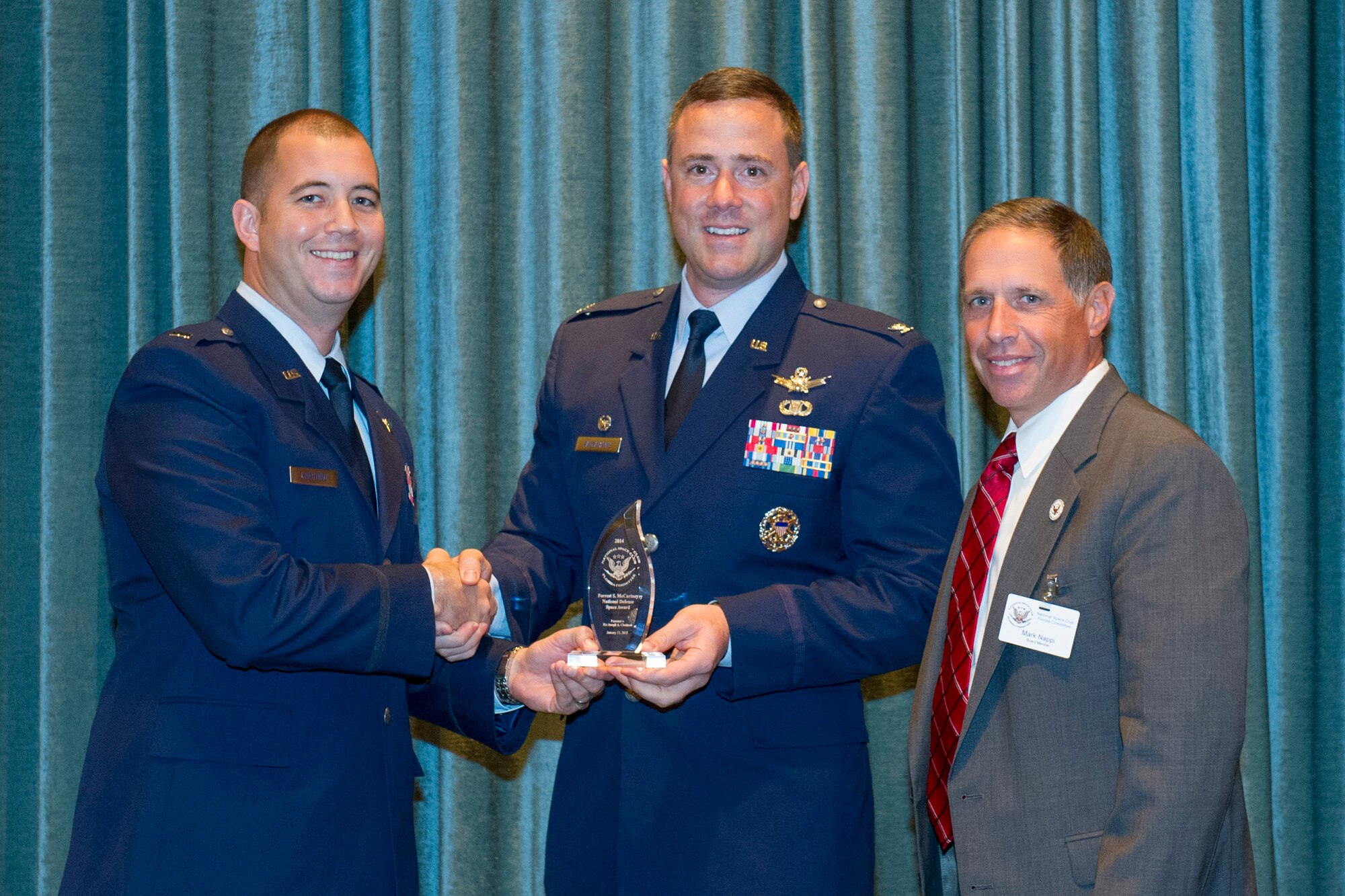 Col. Thomas Falzarano, 45th Operations Group commander, (center), and Mark Nappi, National Space Club Florida board member, (right), present 1st Lt. Joseph A. Chestnut, Jr., (left), with the 2014 Forrest S. McCarthy National Defense Space award recipient at Cape Canaveral, Fla., Jan. 13. The NSC said they are proud to recognize Chestnut for his contribution to the defense of our nation through his leadership and expertise of space capabilities. (U.S. Air Force photo/Matthew Jurgens) (Released)