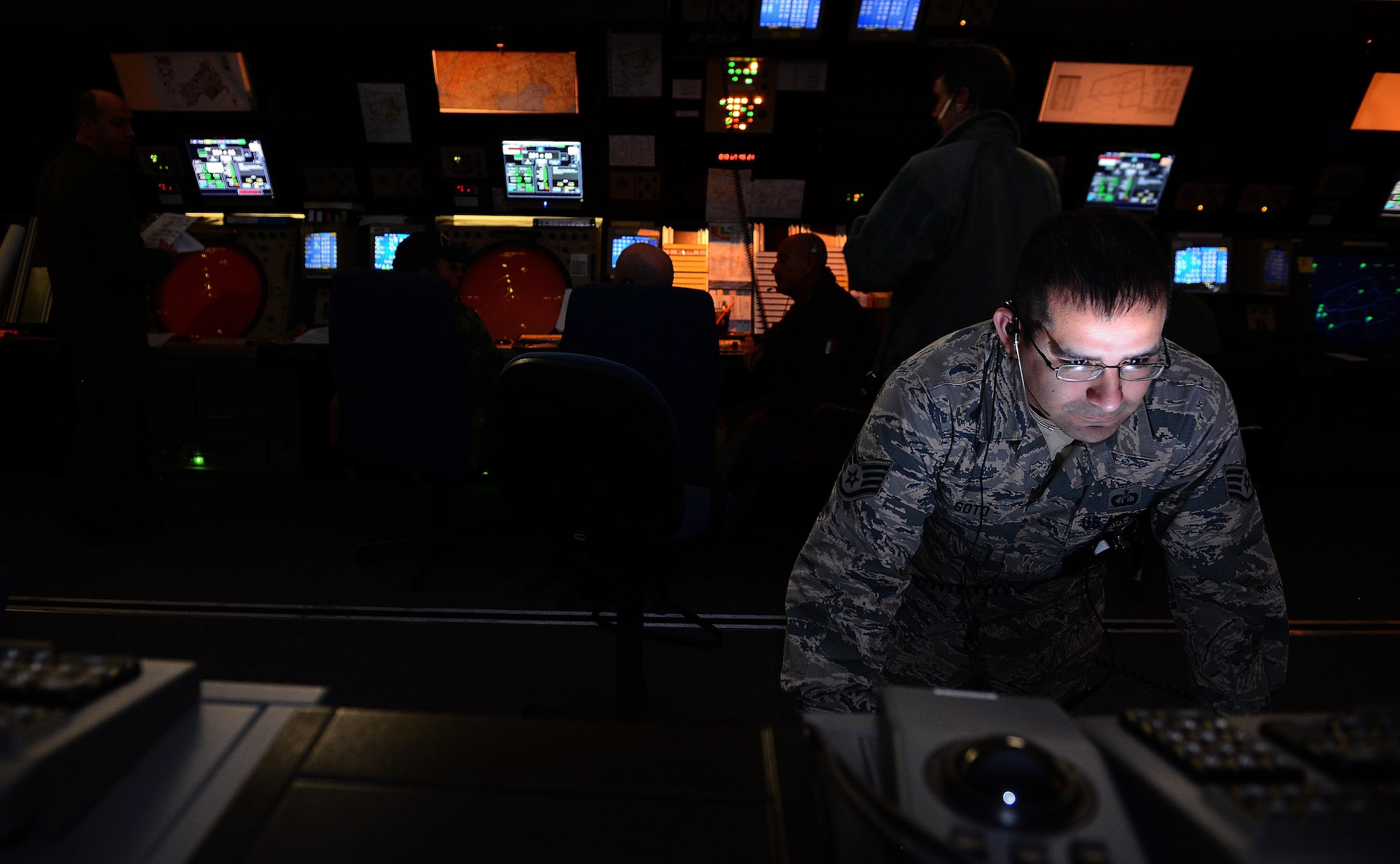 Staff Sgt. James Soto, 31st Operations Support Squadron air traffic controller, looks at map coordinates, Jan. 13, 2014, in the Radar Approach Control building at Aviano Air Base, Italy. Aviano’s air traffic controllers are responsible for all movement within the airfield, airspace coordination and ensuring safe operations. (U.S. Air Force photo/Senior Airman Matthew Lotz)