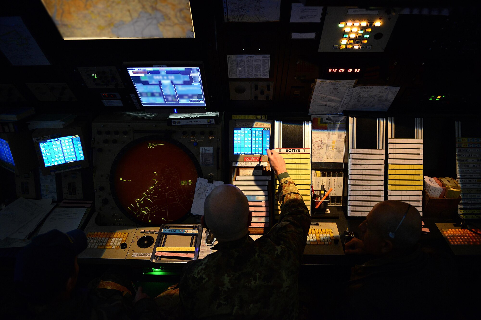 Italian air force air traffic controllers communicate information to F-16 Fighting Falcon pilots, Jan. 13, 2014, in the Radar Approach Control building at Aviano Air Base, Italy.  Italian air traffic controllers assist with flying operations by eliminating the language disconnect between the U.S. controllers and  Italian control towers. (U.S. Air Force photo/Senior Airman Matthew Lotz)