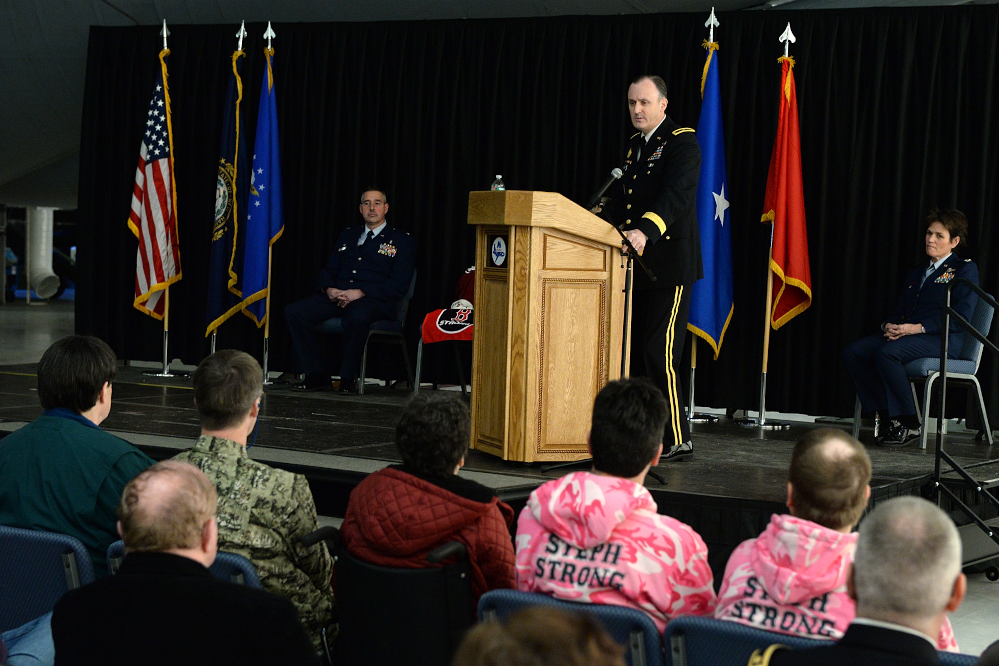 Brig. Gen. Craig E. Bennett, New Hampshire Army National Guard commander, speaks at the podium during a posthumous retirement ceremony for Lt. Col. Stephanie Riley on base Jan. 10. Riley was a occupational health nurse assigned to the N.H. National Guard Joint Forces Headquarters in Concord. (U.S. Air National Guard photo by Tech. Sgt. Mark Wyatt)