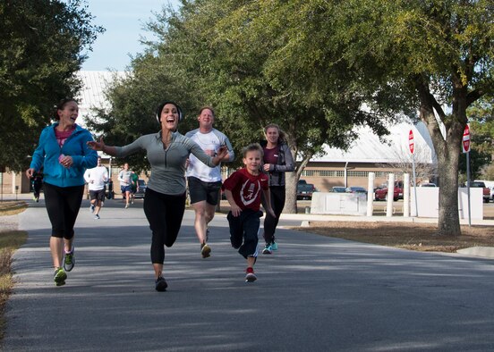 1st Lt Bobbiejean Johnson, 919th Special Operations Wing, races a young contestant to the finish line during the Resolution 5k run Jan. 10 at Duke Field, Fla.  The proceeds benefit the Senior Airman Josh Santos Memorial.  More than 50 people participated.  (U.S. Air Force photo/Tech. Sgt. Jasmin Taylor)