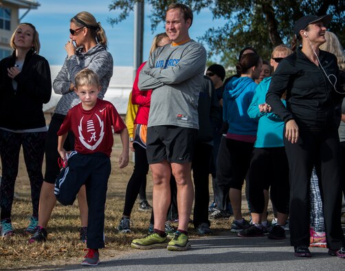 The youngest participant stretches while waiting to start the Resolution 5k run Jan. 10 at Duke Field, Fla.  The proceeds benefit the Senior Airman Josh Santos Memorial.  More than 50 people participated.  (U.S. Air Force photo/Tech. Sgt. Jasmin Taylor)