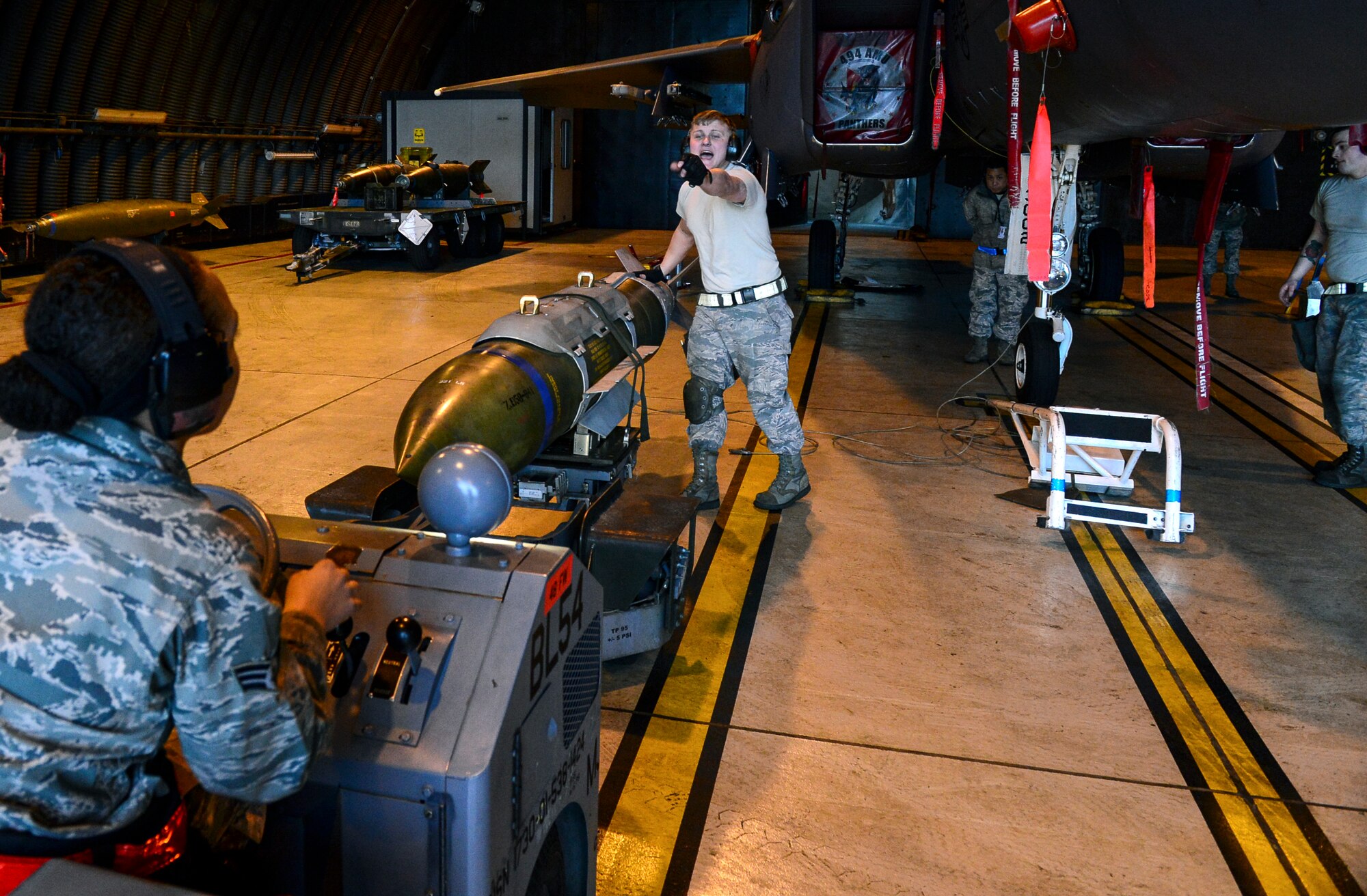 A weapons load crew team from the 494th Aircraft Maintenance Unit works together to transport a Guided Bomb Unit-31 munition on an MJ-1 Lift Truck during the Load Crew of the Quarter competition at Royal Air Force Lakenheath, England, Jan. 12, 2015. The competition tested teams’ abilities to arm F-15C Eagle in a fast and safe manner. (U.S. Air Force photo by Airman 1st Class Erin R. Babis/Released)